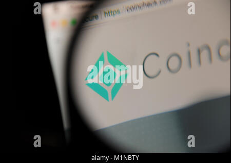 The Coinbase website seen through a magnifying glass Stock Photo