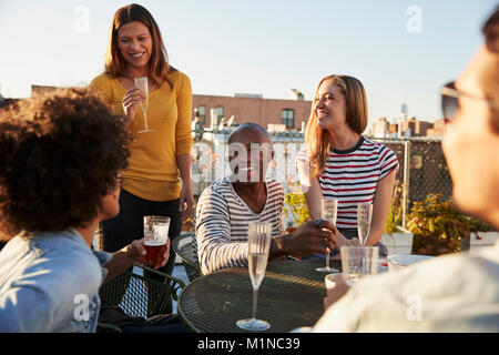 Friends having drinks on a New York rooftop Stock Photo
