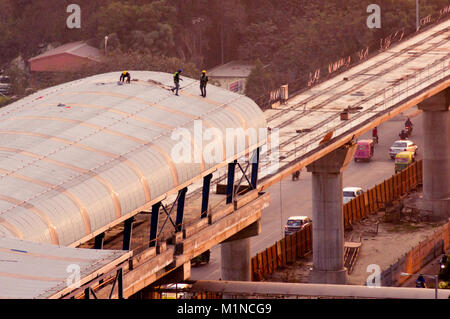 Construction men standing on the roof of a metro station in Delh Stock Photo