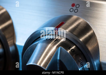 Stainless steel control knob on cooker Stock Photo