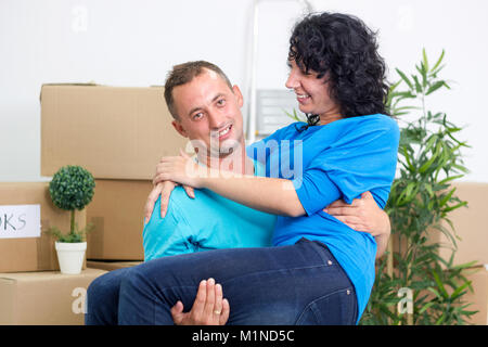 smiling young couple in the new house,man is holding his wife Stock Photo