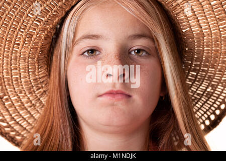 portrait of beautiful freckled young girl wearing straw hat Stock Photo