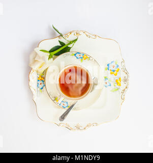 flatlay with elegant tea set with rose flower reflection iat the urface of liquid surrounde by rose petals and flowers Stock Photo