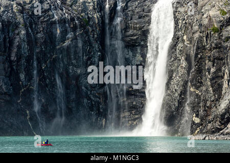 Rafters navigate along a waterfall from the Northland Glacier along Blackstone Bay near Whittier in Southcentral Alaska. Stock Photo