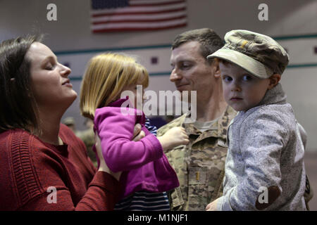 U.S. Army 2nd Lt. Juraj Bedi, 612th Movement Control Team, 53rd Movement Control Battalion, 7th Transportation Brigade (Expeditionary) movements control officer, spends time with his family after a deployment ceremony at Joint Base Langley-Eustis, Va., Jan. 26, 2018. The ceremony was held for family members to wish their Soldiers well as they prepare for their deployment in support of Operation Atlantic Resolve. (U.S. Air Force Stock Photo