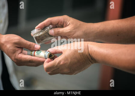 Drug addict buying narcotics and paying Stock Photo