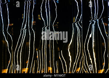 Light night glare in the form of abstraction in architecture. Stock Photo
