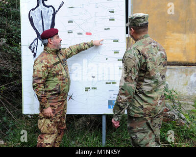Italian Army Col. Marco Becherini, Folgore (ABN) Brigade Training Center Commander, talks with U.S. Army Lt. Col. Ismael B. Natividad, Training Support Activity Europe (TSAE) Director, during his visit at Valle Ugione Training Area, , Livorno, Italy, Jan 30, 2018.(