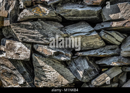 The stones are stacked on top of each other and form a wall. Stock Photo