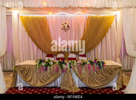 A beautifully decorated table for honeymooners close-up. Stock Photo