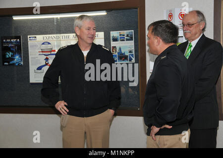 PANAMA CITY, Florida - Commander, Naval Sea Systems Command Vice Adm. Thomas Moore, USN, speaks with Naval Surface Warfare Center Panama City Division Commanding Officer Capt. Aaron Peters, USN, and Business Operations Department Head (Code 10) Mike Adams Tuesday, Jan. 30, 2018. Moore visited NSWC PCD to learn how the Division expands the advantage in the littorals. U.S. Navy Katherine Mapp Stock Photo