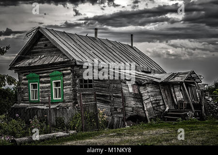 An old rickety dilapidated residential log wooden house.
