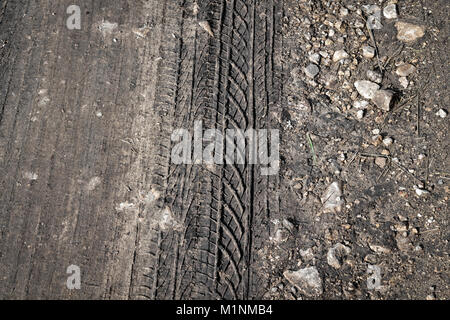 A trace from the tread of the car tires on a dirty road. Stock Photo