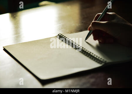 Writing Note on wooden table, Vintage picture tone Stock Photo