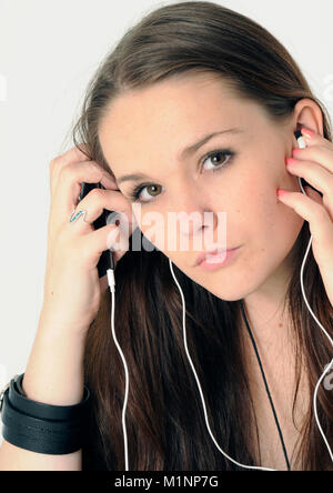 Young brunette listening to iPod Stock Photo