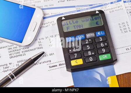 Tan generator with check card and statement of bank account | usage worldwide Stock Photo