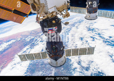 Outer Space-December 30, 2017: Awesome view of the planet Earth and the Soyuz spaceship docked to the ISS. This image elements furnished by NASA Stock Photo