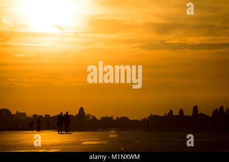 Strolling and cycling on a runway of the Tempelhofer Feld, Berlin 2017. Stock Photo