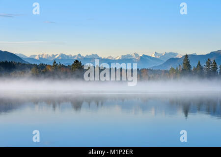 Autumn morning,with early morning fog at the Kirchsee,near Sachsenkam,alpine panorama with Karwendel Mountains,Upper Bavaria Stock Photo