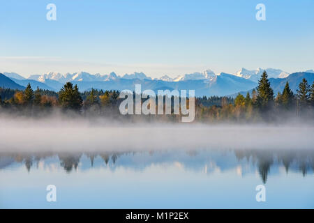 Autumn morning,with early morning fog at the Kirchsee,near Sachsenkam,alpine panorama with Karwendel Mountains,Upper Bavaria Stock Photo