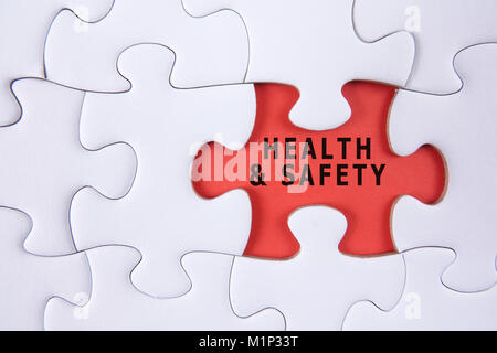 HEALTH AND SAFETY CONCEPT with white jigsaw puzzle Stock Photo