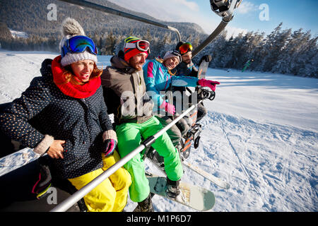 friends skiers and snowboarders enjoying in the slopes at winter vacations on mountain Stock Photo