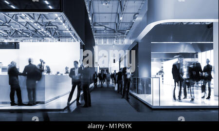 blurred people at a trade fair hall Stock Photo