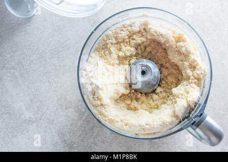 Dough prepaing in a food processor. Batter making fast and easy. Stock Photo