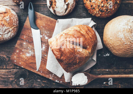 Delicious freshly baked bread on wooden background Stock Photo