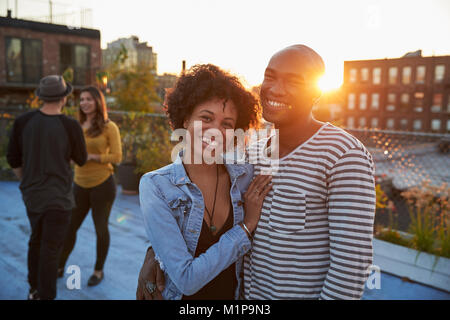 Young black couple embracing at a rooftop party Stock Photo