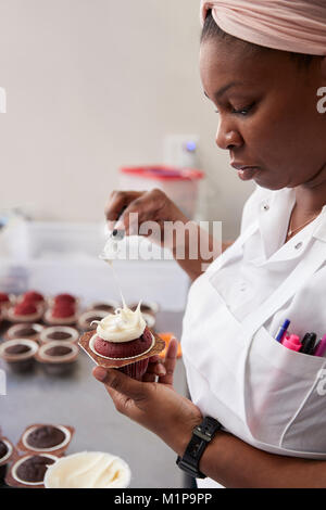 Young black woman preparing food in a bakery, close up Stock Photo