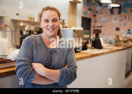 Young woman smiling to camera at the counter in a bakery Stock Photo
