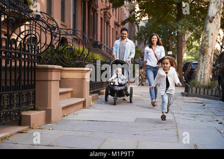 Family taking a walk down the street, close up Stock Photo