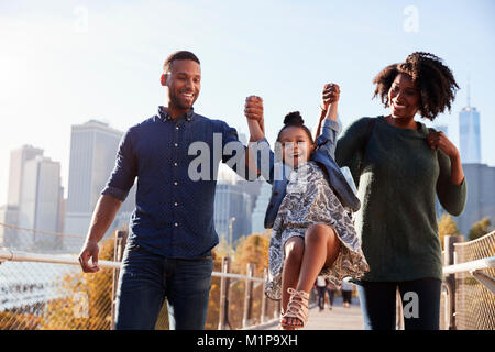 Young family taking a walk on footbridge, close up Stock Photo