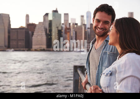 Young couple standing on quayside, side view Stock Photo