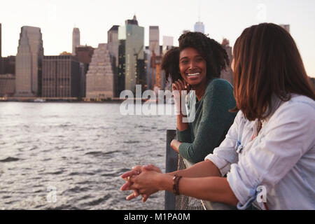 Young couple standing on quayside, side view Stock Photo