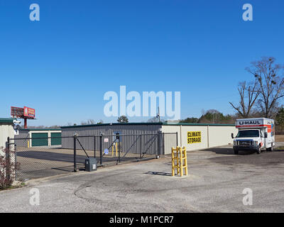 Exterior front entrance gate to a self storage facility that is climate controlled and rents UHAUL trucks in Montgomery Alabama United States. Stock Photo