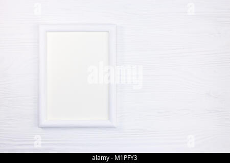 empty white wooden picture frame on white wooden background with copy space Stock Photo