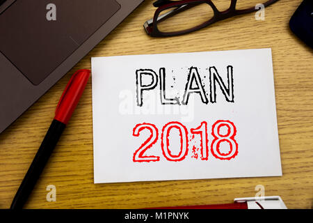 Handwriting Announcement text showing Plan 2018. Business concept for Planning Strategy Action Plan written on paper, wooden background in office copy Stock Photo