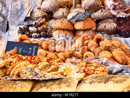 Bakery scene with fresh baked goods, ciabatta and bread variations. Market stall, food staple. Stock Photo