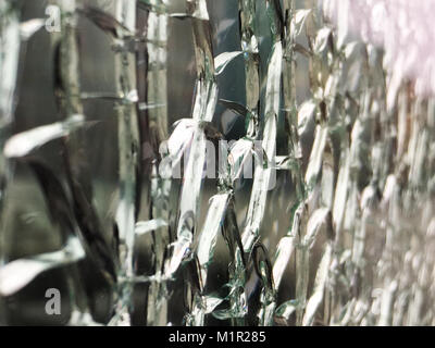 Close-up of broken glass wall shot at an angle with the blur at the right side of the frame Stock Photo