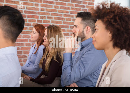 Group Of Businesspeople Attending Meeting In Office Stock Photo