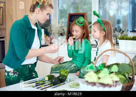 Mother with children cooking at kitchen Stock Photo