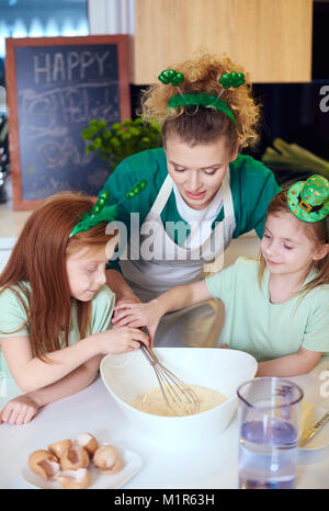 Children with wire whisk baking cupcakes at kitchen Stock Photo