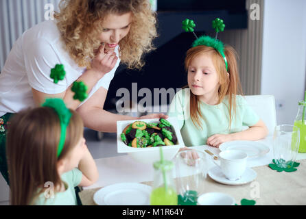 Mother offering children tasty cookies Stock Photo