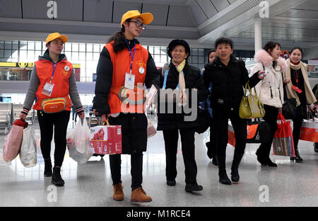 Nanning, China's Guangxi Province. 1st Feb, 2018. Volunteers offer help to passengers at Nanning East Railway Station, in Nanning, south China's Guangxi Province, Feb. 1, 2018. The 2018 Spring Festival travel rush, known as the Chunyun, started on Thursday and will last till March 12. About 2.98 billion trips are expected to be made during the Chunyun. The Spring Festival, or Chinese Lunar New Year, falls on Feb. 16 this year. Credit: Huang Xiaobang/Xinhua/Alamy Live News Stock Photo