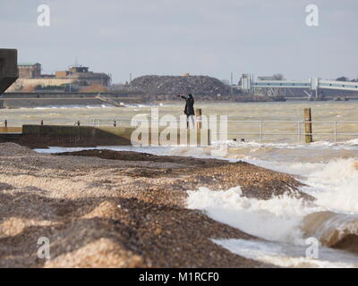 Sheerness, Kent, UK. 1st Feb, 2018. UK Weather: a young woman takes a surge tide selfie as the Neptune Jetty is covered by water during today's surge tide. Sunny spells but with a strong and cold westerly wind. Credit: James Bell/Alamy Live News Stock Photo