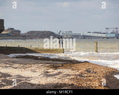 Sheerness, Kent, UK. 1st Feb, 2018. UK Weather: a young woman takes a surge tide selfie as the Neptune Jetty is covered by water during today's surge tide. Sunny spells but with a strong and cold westerly wind. Credit: James Bell/Alamy Live News Stock Photo