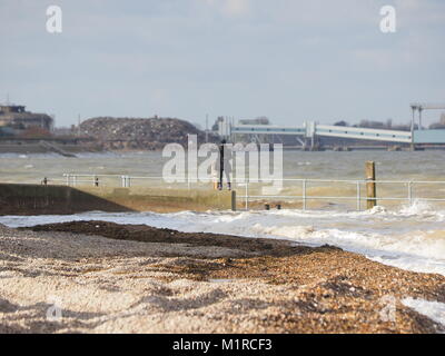 Sheerness, Kent, UK. 1st Feb, 2018. UK Weather: a young woman takes a surge tide selfie as the Neptune Jetty is covered by water during today's surge tide. Sunny spells but with a strong and cold westerly wind. Credit: James Bell/Alamy Live News Stock Photo