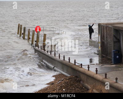 Sheerness, Kent, UK. 1st Feb, 2018. UK Weather: a young woman takes a surge tide selfie as the Neptune Jetty is covered by water during today's surge tide. Sunny spells but with a strong and cold westerly wind. Credit: James Bell/Alamy Live News Stock Photo